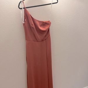 Coral one-strap bridesmaid dress.